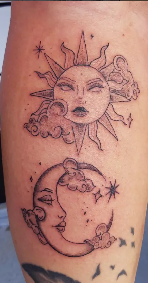 Bold traditional sun and moon face tattoo on the forearm.