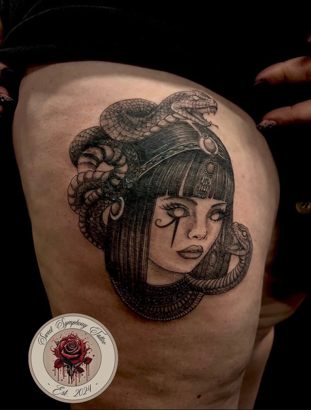 Healed thigh cover-up tattoo of a woman with snakes by Lilly at Sweet Symphony Tattoo