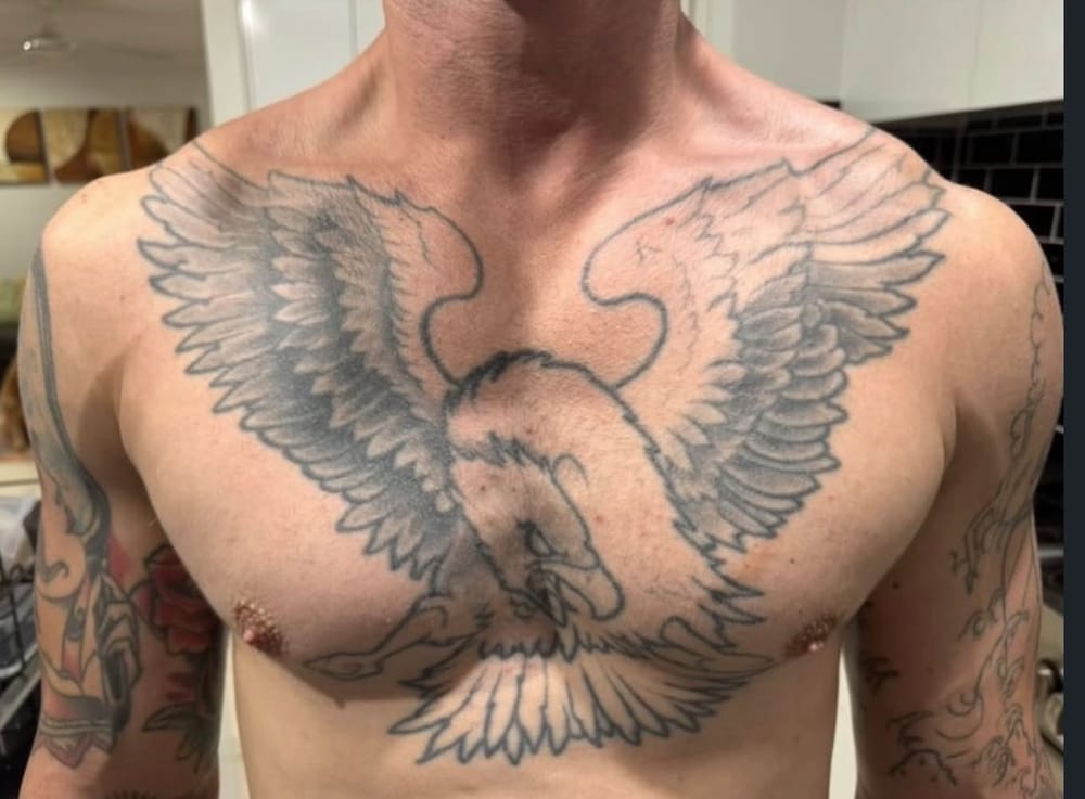Outline stage of a chest tattoo rework by Sarah at Sweet Symphony Tattoo