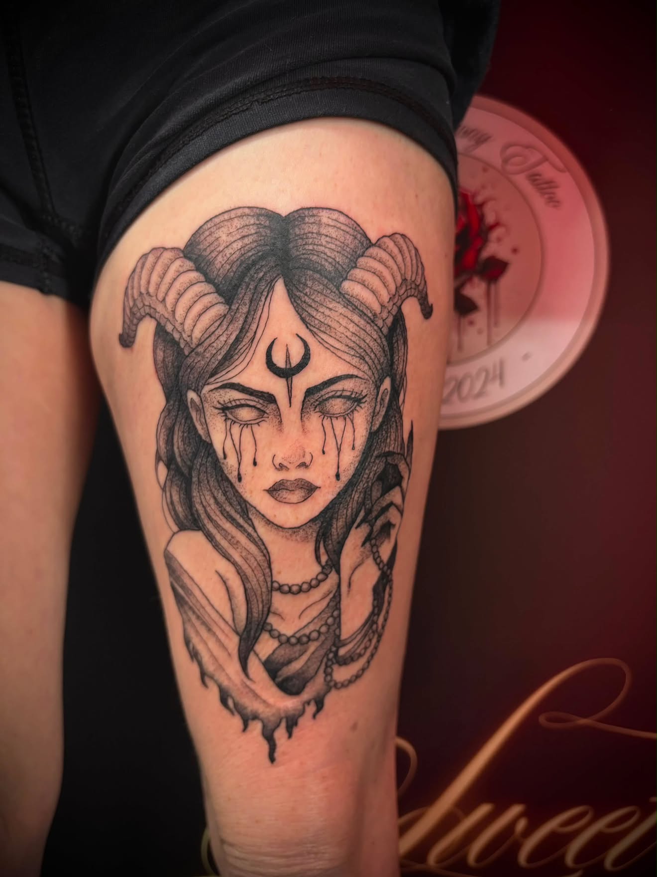 Fine-line Asian-style dragon tattoo winding through cherry blossoms across the back.