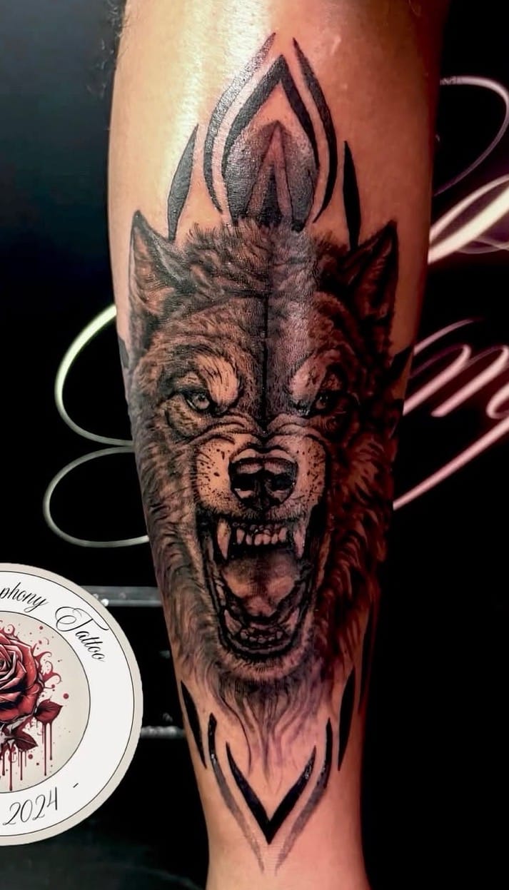 Black and grey roaring wolf tattoo by Sweet Symphony Tattoo